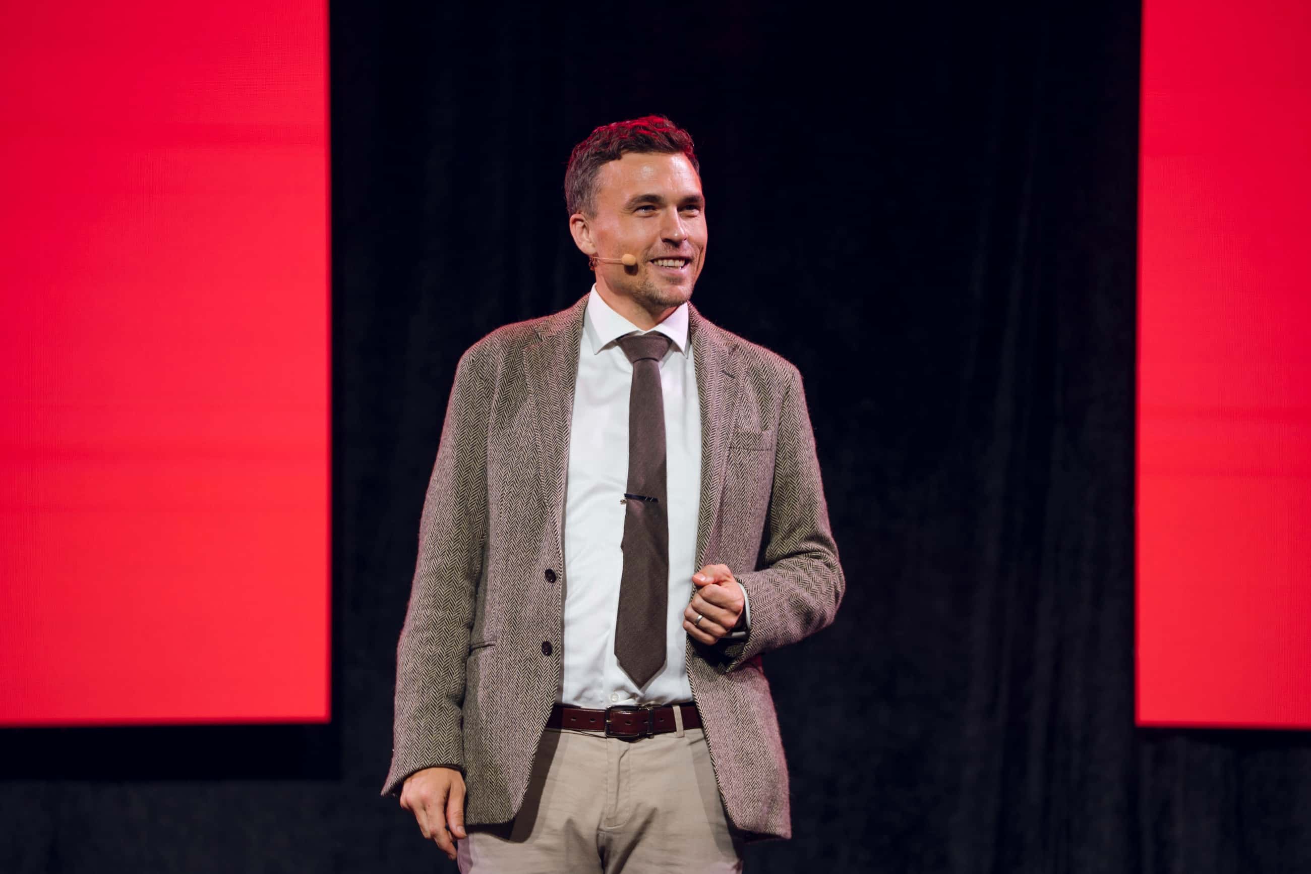 Andy Nunn presenting on stage at a KFC corporate event
