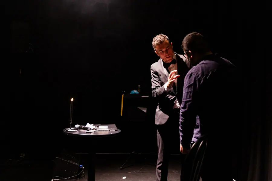 Andy Nunn performing a stage mentalism routine with a volunteer