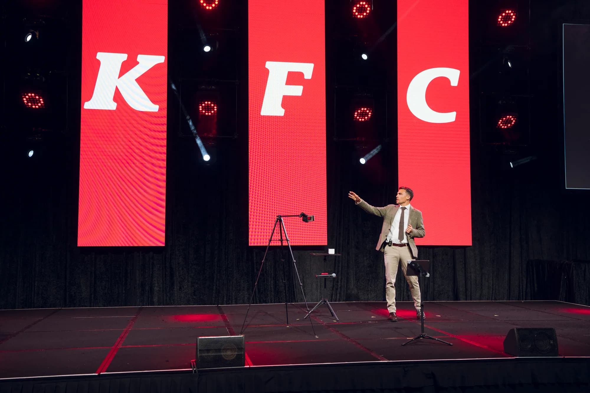 Andy Nunn speaking on a large corporate conference stage