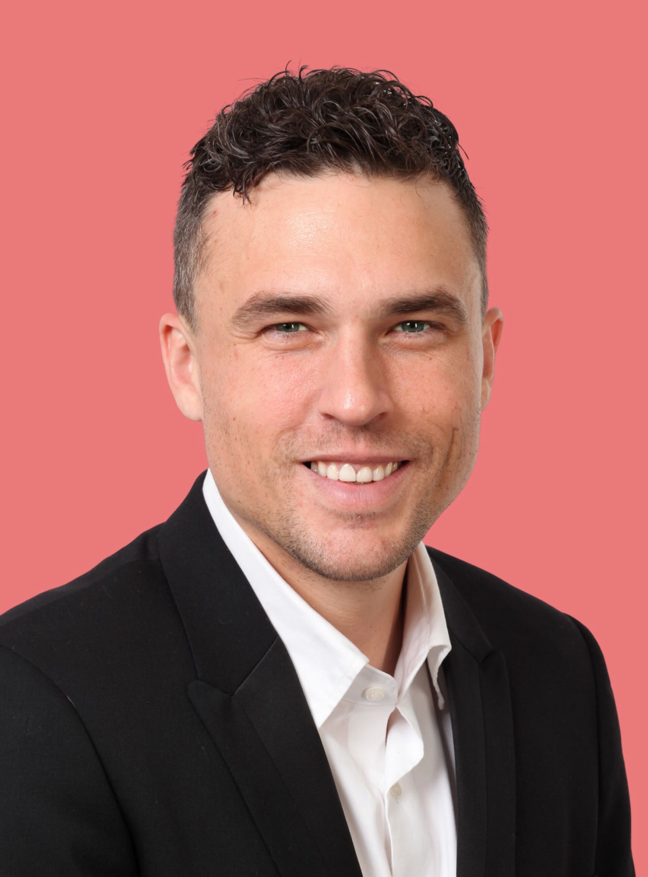 Andy Nunn smiling in a black suit