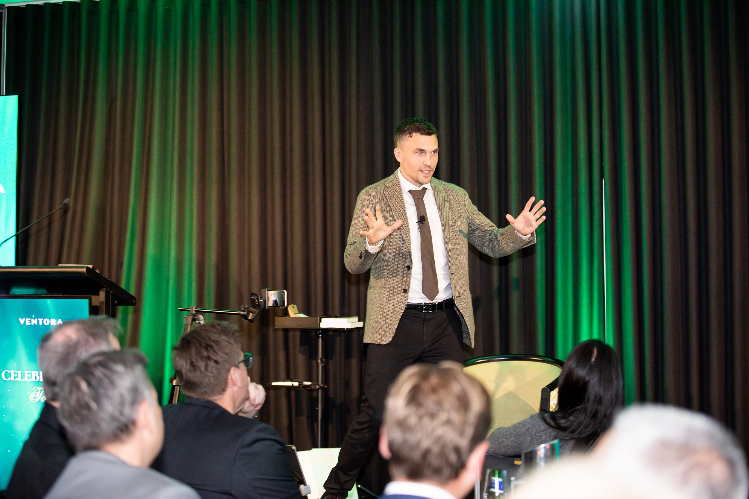 Andy Nunn delivering a keynote to a seated conference audience