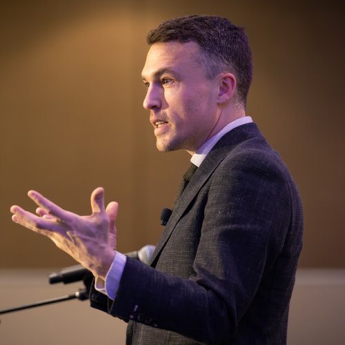 Andy Nunn speaking on stage during a mentalism performance