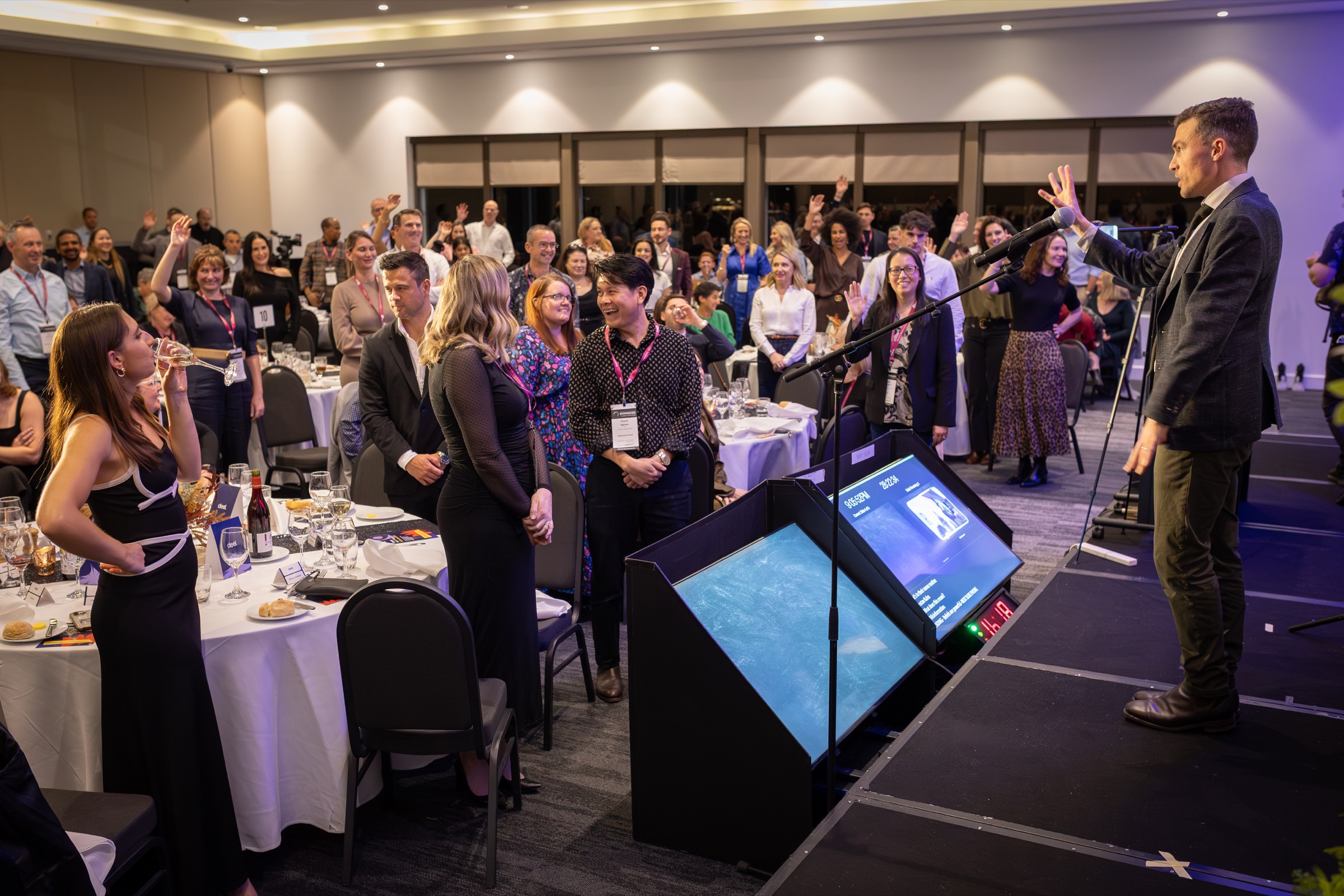 Andy Nunn speaking at a corporate event with audience participation