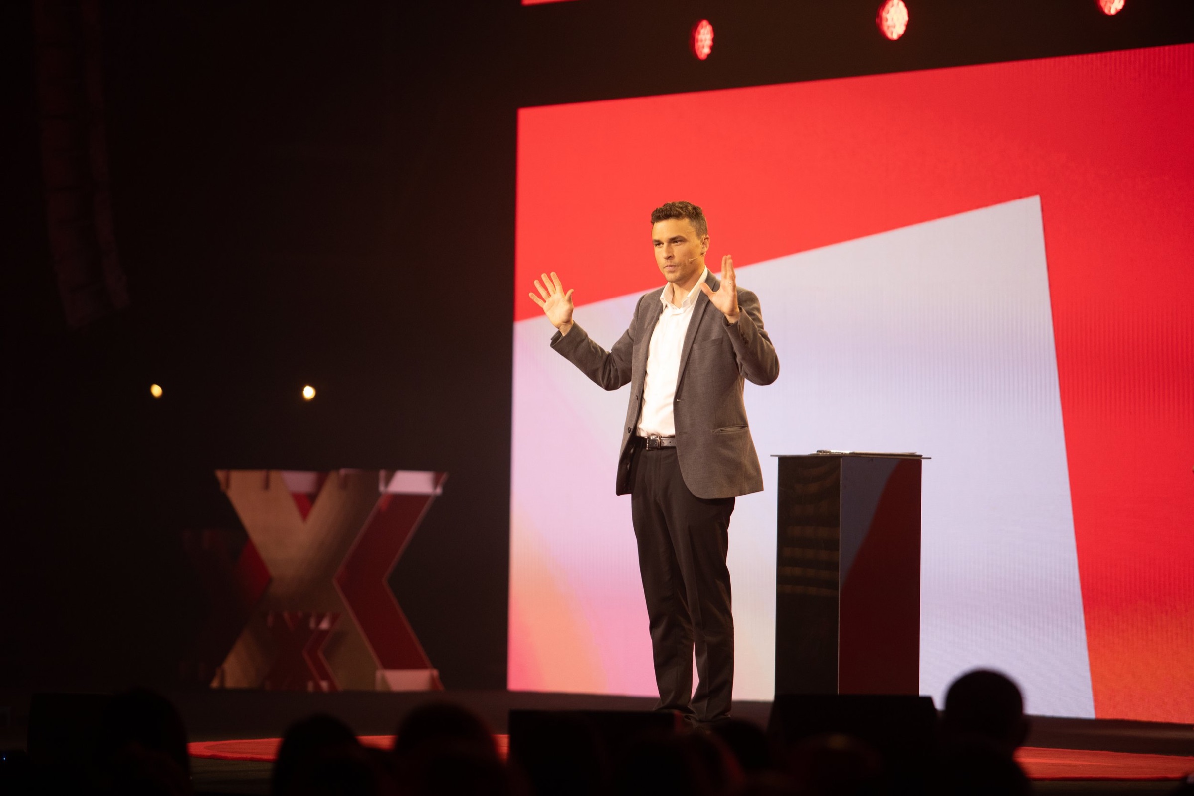 Andy Nunn presenting on stage as a keynote speaker in New Zealand