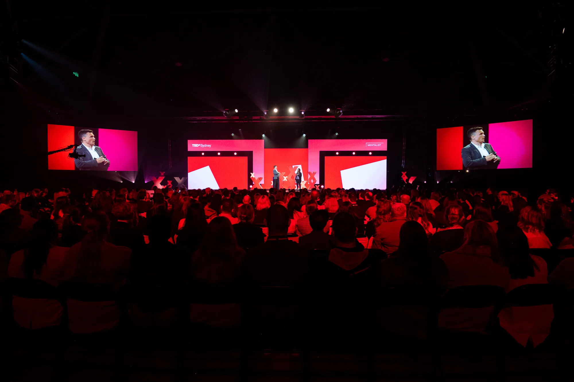 Full theatre audience watching motivational speaker Andy Nunn present live