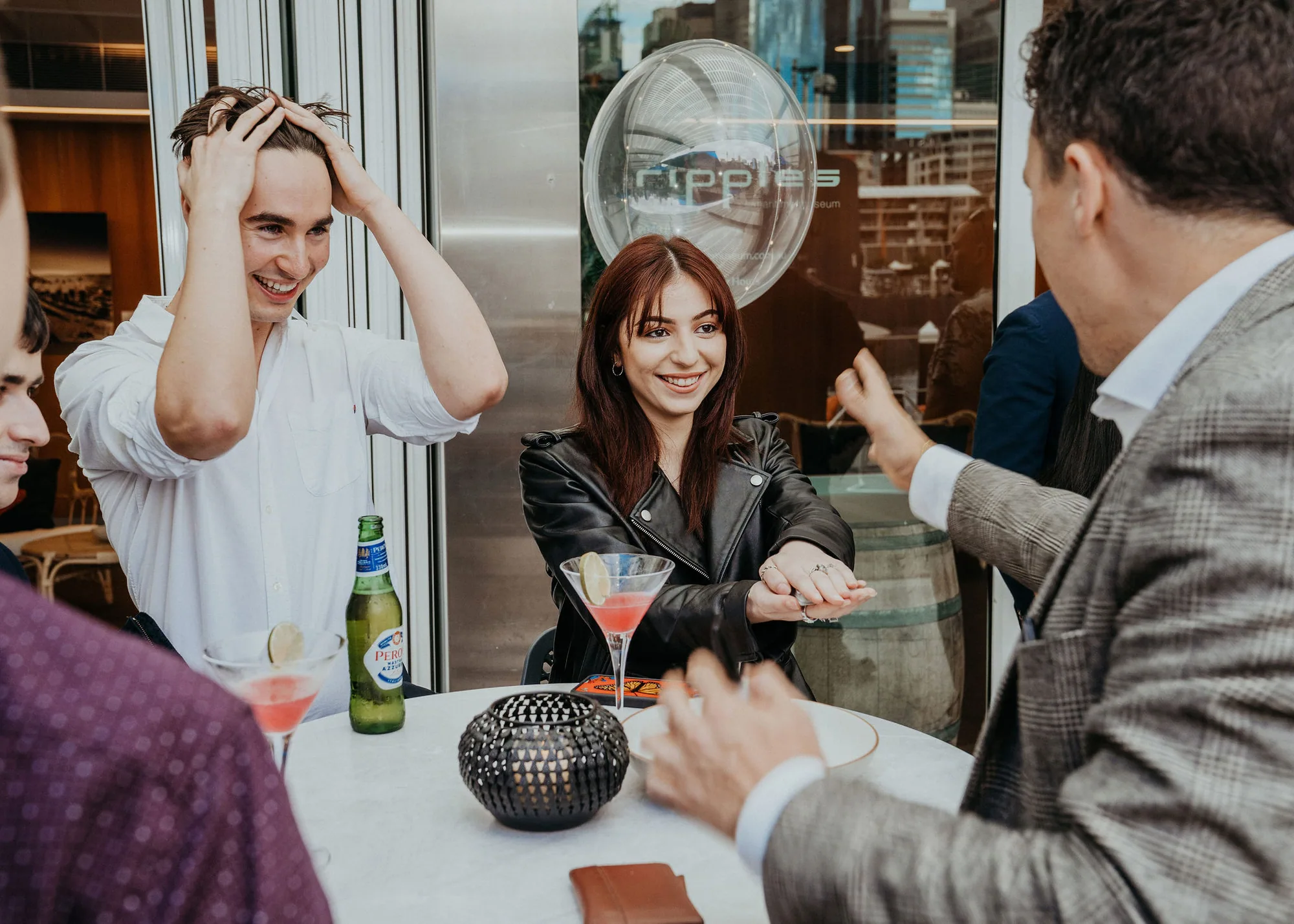 Sydney corporate event guests sharing a surprised reaction to Andy Nunn's mentalism